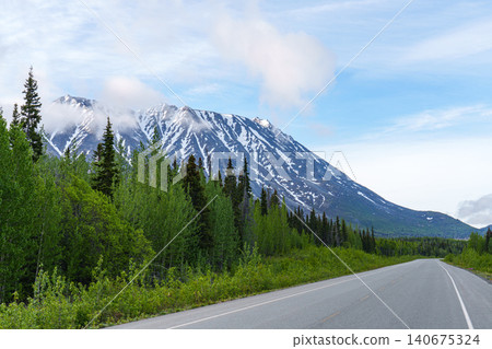 The Haines Highway, which runs from Canada's Yukon Territory through British Columbia to southern Alaska, is lined with snow-capped mountains. The Haines Highway, which runs from Canada's Yukon Territory through British Columbia to southern Alaska, is lined with snow-capped mountains. 140675324