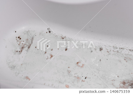 Old, stained bathtub with visible dirt, grime. Scene conveys neglect and need for deep cleaning in a domestic bathroom. Bathtub covered in layers of dirt. Old, stained bathtub with visible dirt, grime. Scene conveys neglect and need for deep cleaning in a domestic bathroom. Bathtub covered in layers of dirt. 140675359