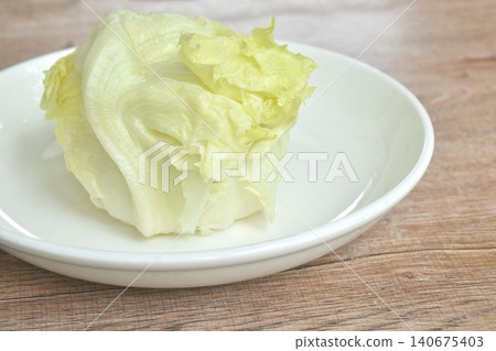 Iceberg or crisphead lettuce fresh vegetable salad on plate Iceberg or crisphead lettuce fresh vegetable salad on plate 140675403