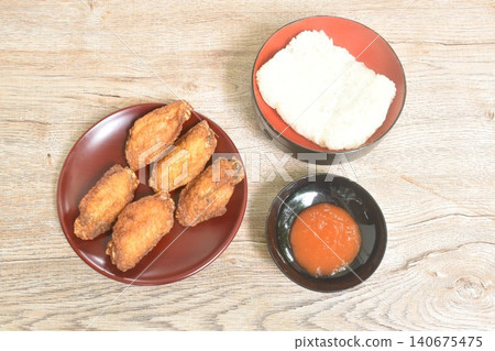 crispy fried chicken wing dipping chili sauce arranging on plate with sticky rice crispy fried chicken wing dipping chili sauce arranging on plate with sticky rice 140675475