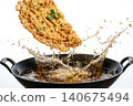Studio photography of fluffy golden Thai style crispy omelette with hot cooking oil splash. 140675494
