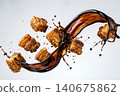 Studio shot of golden crispy pork belly cubes with dark sweet soy sauce splash. 140675862