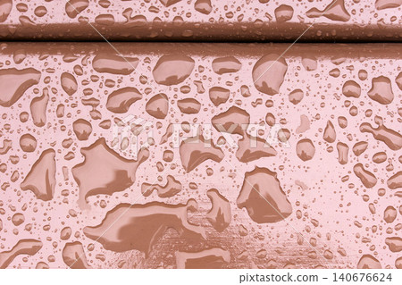 Water droplets on a wooden surface after rain at a park during the afternoon hours in early autumn Water droplets on a wooden surface after rain at a park during the afternoon hours in early autumn 140676624