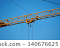 Industrial crane in action at a skyscraper construction site 140676625