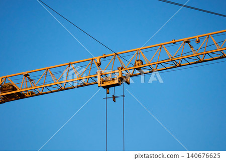 Industrial crane in action at a skyscraper construction site Industrial crane in action at a skyscraper construction site 140676625