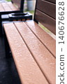 Detailed texture of water droplets on a brown wooden surface, abstract nature background with bokeh 140676628