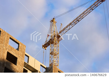 Tower crane cabin and mast at a high-rise building site Tower crane cabin and mast at a high-rise building site 140676629