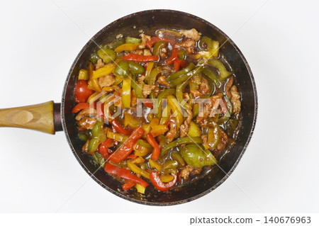 Cooking pork stir fry with fresh bell peppers in a frying pan Cooking pork stir fry with fresh bell peppers in a frying pan 140676963