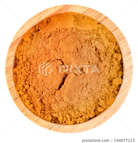 Top view of a small wooden bowl filled with aromatic turmeric powder isolated. Perfect for culinary, healthcare, and wellness content. High quality spice photography. Top view of a small wooden bowl filled with aromatic turmeric powder isolated. Perfect for culinary, healthcare, and wellness content. High quality spice photography. 140677223