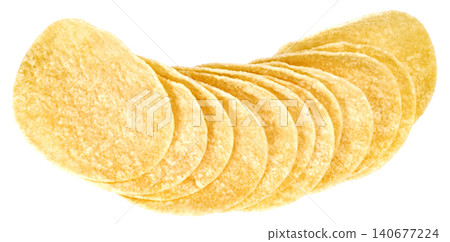 A neat row of thin golden potato chips arranged in a curve against. Crunchy salty snacks with uniform texture. Isolated image for food marketing and advertisement designs. A neat row of thin golden potato chips arranged in a curve against. Crunchy salty snacks with uniform texture. Isolated image for food marketing and advertisement designs. 140677224