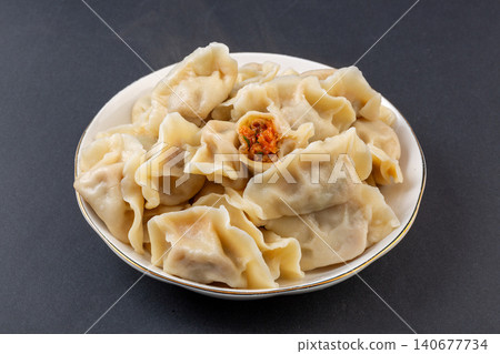 Steamed Korean style kimchi and pork dumplings Mandu Mandoo served on white plate Steamed Korean style kimchi and pork dumplings Mandu Mandoo served on white plate 140677734