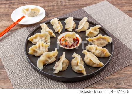 Steamed Korean style kimchi and pork dumplings Mandu Mandoo served on white plate Steamed Korean style kimchi and pork dumplings Mandu Mandoo served on white plate 140677736