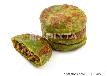 Crispy green herb thin crust meat pies stuffed with savory beef filling isolated on a white background. Crispy green herb thin crust meat pies stuffed with savory beef filling isolated on a white background. 140678533