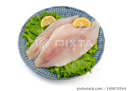 Raw Fresh Fish Fillets with Lemon and Lettuce on Plate, Fresh Seafood Ingredients Raw Fresh Fish Fillets with Lemon and Lettuce on Plate, Fresh Seafood Ingredients 140678564