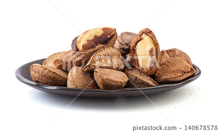 raw Brazil nuts in shells and cracked kernels isolated on a pure white background raw Brazil nuts in shells and cracked kernels isolated on a pure white background 140678578