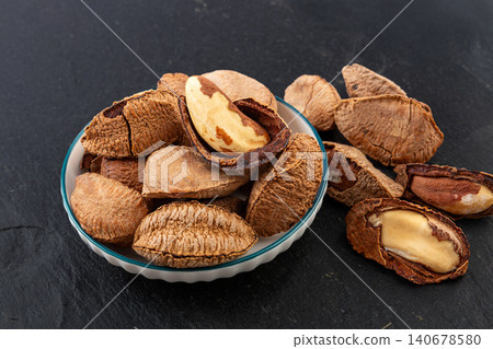 Close-up of raw Brazil nuts in shells and cracked kernels Close-up of raw Brazil nuts in shells and cracked kernels 140678580