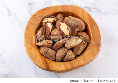 Close-up of raw Brazil nuts in shells and cracked kernels Close-up of raw Brazil nuts in shells and cracked kernels 140678581