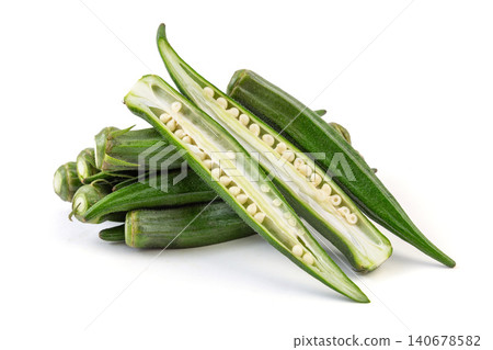 A row of fresh green okra pods with one sliced open to show white seeds isolated on a white background. A row of fresh green okra pods with one sliced open to show white seeds isolated on a white background. 140678582
