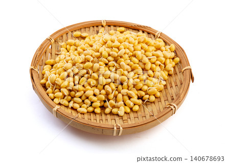 The bamboo basket contains sprouted yellow soybeans with tiny sprouts growing on them, against a white background. The bamboo basket contains sprouted yellow soybeans with tiny sprouts growing on them, against a white background. 140678693