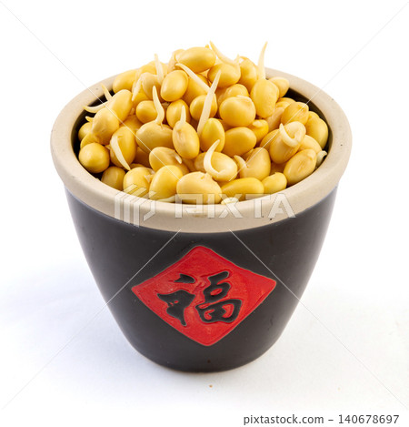germinated yellow soybeans with tiny sprouts in a black bowl isolated on white background germinated yellow soybeans with tiny sprouts in a black bowl isolated on white background 140678697