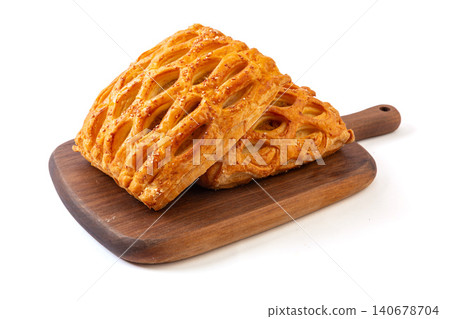 freshly baked lattice puff pastries with savory curry chicken filling isolated on a white background. 140678704