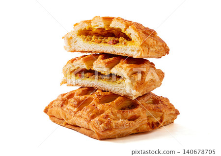 freshly baked lattice puff pastries with savory curry chicken filling isolated on a white background. freshly baked lattice puff pastries with savory curry chicken filling isolated on a white background. 140678705