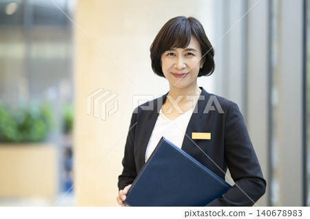 Portrait of a middle-aged businesswoman smiling directly at the camera. Portrait of a middle-aged businesswoman smiling directly at the camera. 140678983