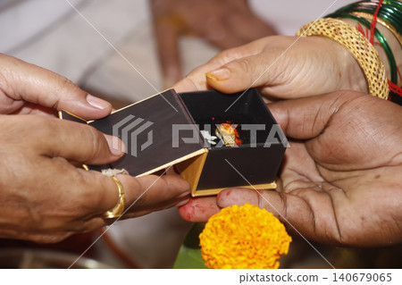 person holding a wedding ring with box in Indian Hindu religion wedding ceremony person holding a wedding ring with box in Indian Hindu religion wedding ceremony 140679065