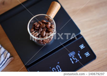 Weighing coffee beans on digital scale Weighing coffee beans on digital scale 140679297