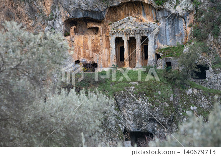 Acropolis, tombs carved in rock of ancient Greek city Tlos in Lycia located on Lycian way. Famous historical site In Antalya region. Popular place for family travel on summer vacation. Fethiye, Turkey Acropolis, tombs carved in rock of ancient Greek city Tlos in Lycia located on Lycian way. Famous historical site In Antalya region. Popular place for family travel on summer vacation. Fethiye, Turkey 140679713