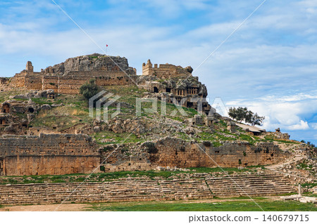 Acropolis, tombs carved in rock of ancient Greek city Tlos in Lycia located on Lycian way. Famous historical site In Antalya region. Popular place for family travel on summer vacation. Fethiye, Turkey Acropolis, tombs carved in rock of ancient Greek city Tlos in Lycia located on Lycian way. Famous historical site In Antalya region. Popular place for family travel on summer vacation. Fethiye, Turkey 140679715