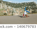 Young boy plays on Iztuzu Beach near Dalyan, Turkey, having fun and doing  handstand on the sand. Active lifestyle, freedom of movement and joyful childhood during summer family travel. 140679783