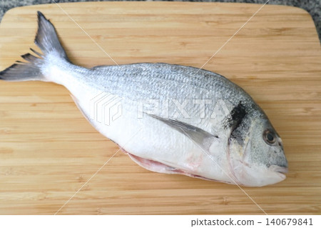 Raw sea fish. A close-up shot of raw fish, cooking delicious food at home. Raw sea fish. A close-up shot of raw fish, cooking delicious food at home. 140679841