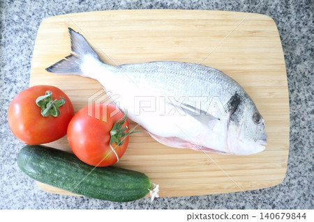 Raw sea fish. A close-up shot of raw fish, cooking delicious food at home. Raw sea fish. A close-up shot of raw fish, cooking delicious food at home. 140679844