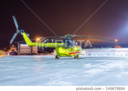 Medical helicopter on winter airport at night Medical helicopter on winter airport at night 140679884