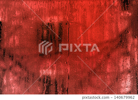 drops of water run down the wet glass. red background. abstract background of red glass with drops of water. Textured backdrop for design and projects. drops of water run down the wet glass. red background. abstract background of red glass with drops of water. Textured backdrop for design and projects. 140679962