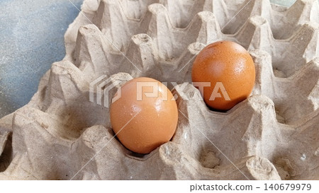 Fresh Brown Egg in Recycled Paper Egg Tray Close Up Fresh Brown Egg in Recycled Paper Egg Tray Close Up 140679979