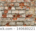Close up of an old weathered brick wall with cracked plaster and exposed red bricks. Rustic grunge masonry texture background 140680221