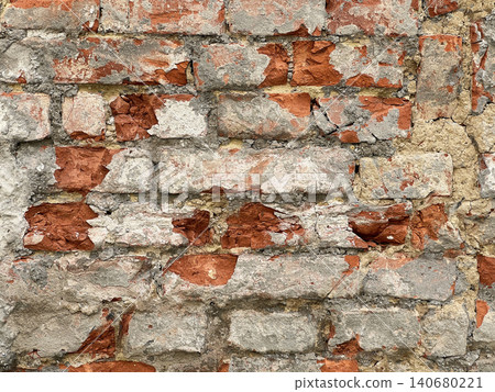 Close up of an old weathered brick wall with cracked plaster and exposed red bricks. Rustic grunge masonry texture background 140680221
