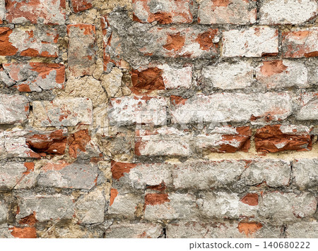 Close up of an old weathered brick wall with cracked plaster and exposed red bricks. Rustic grunge masonry texture background Close up of an old weathered brick wall with cracked plaster and exposed red bricks. Rustic grunge masonry texture background 140680222