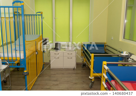 Pediatric hospital ward with colorful blue and yellow infant cribs and medical monitoring equipment. Pediatric hospital ward with colorful blue and yellow infant cribs and medical monitoring equipment. 140680437