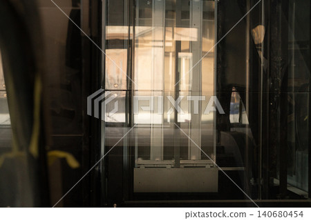 Abstract modern architectural reflection of glass windows and urban structures in golden light. Abstract modern architectural reflection of glass windows and urban structures in golden light. 140680454