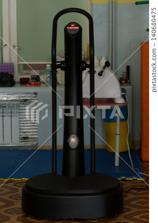 Professional whole body vibration machine for fitness training and physical therapy in modern gym interior. Professional whole body vibration machine for fitness training and physical therapy in modern gym interior. 140680475