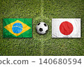 Brazil vs. Japan flags on soccer field 140680594