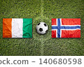 Ivory Coast vs. Norway flags on a soccer field 140680598
