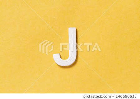 Letter J of the alphabet isolated on yellow background, top view 140680635