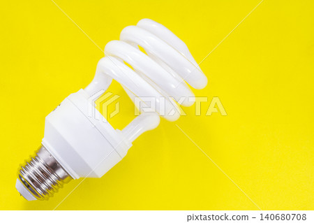 Fluorescent light bulb on yellow background, technology that contains polluting gases Fluorescent light bulb on yellow background, technology that contains polluting gases 140680708