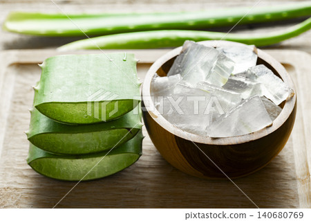 aloe vera and pieces of its pulp on a wooden pit aloe vera and pieces of its pulp on a wooden pit 140680769