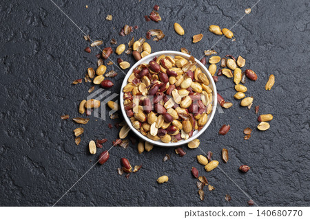 Pile of roasted peanuts on black background, space for text Pile of roasted peanuts on black background, space for text 140680770