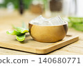 aloe vera and pieces of its pulp on a wooden pit 140680771